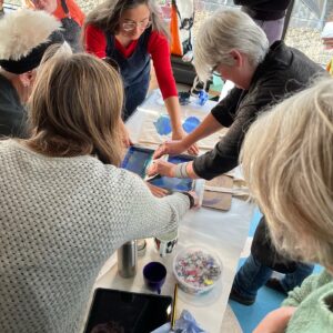 A group of people screen printing