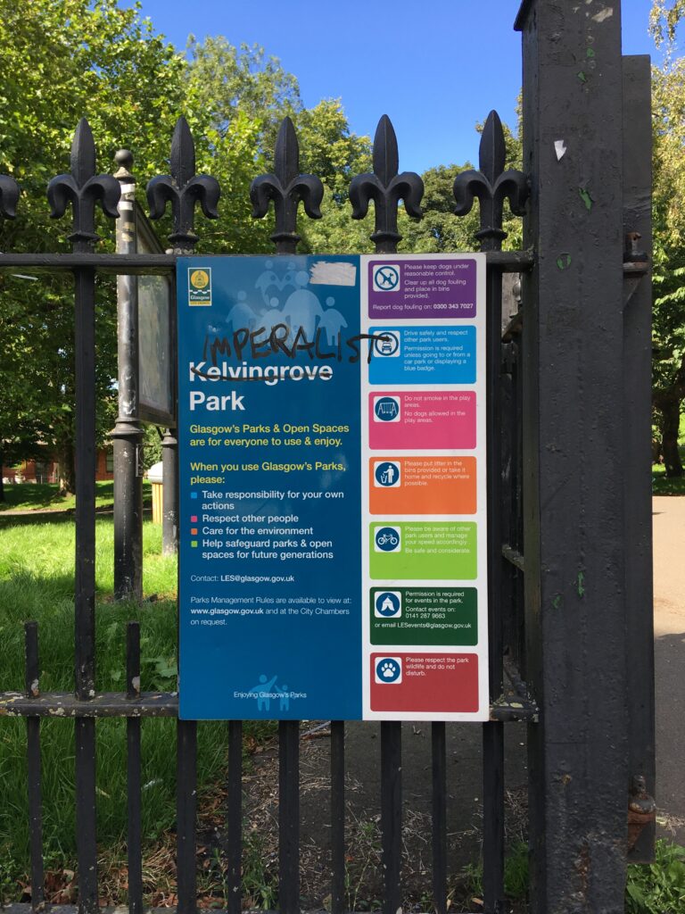 A photograph of a sign at Kelvingrove Park, where Kelvingrove has been scored out and someone has written 'Imperialist' above it.