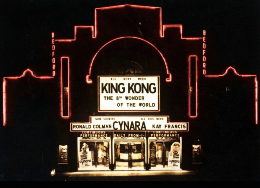 Glasgow's Beresford cinema, photo taken at night so there's red lighting illuminating it. The film showing that day is King Kong.