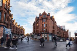 Glasgow High Street with people crossing the road.