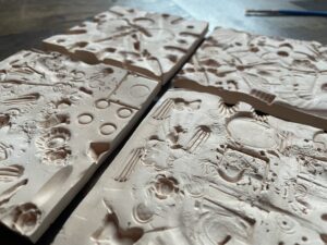 4 tiles with patterns moulded into them