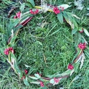 A finished wreath lying on some grass.