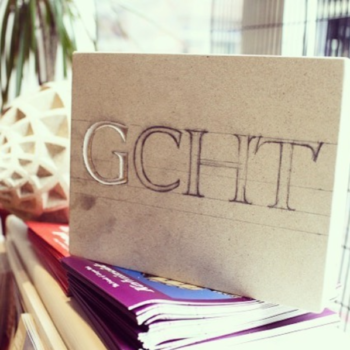 A photograph of a white limestone block with GCHT written on it